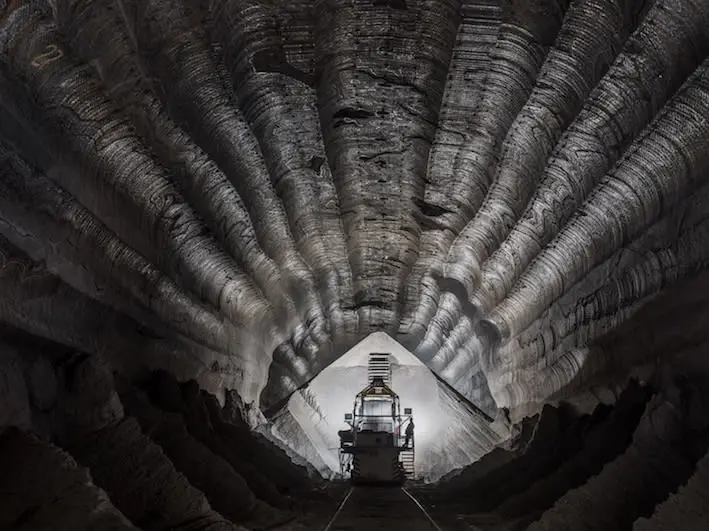 Image of dark cavernous sea-shell like interior of a working mine in Russia. 