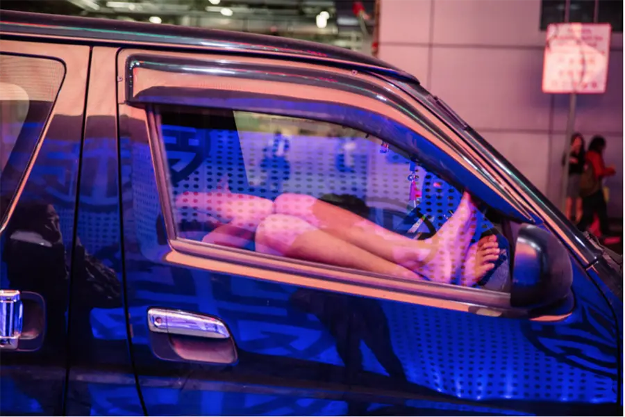 Pink and blue light on car at night