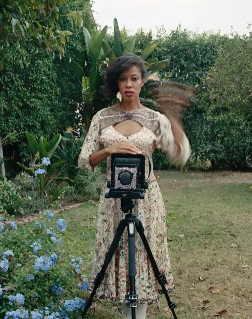 Woman standing behind large format camera