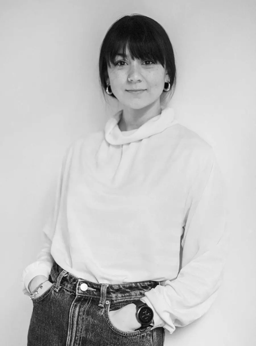 A black and white photograph of a person standing.