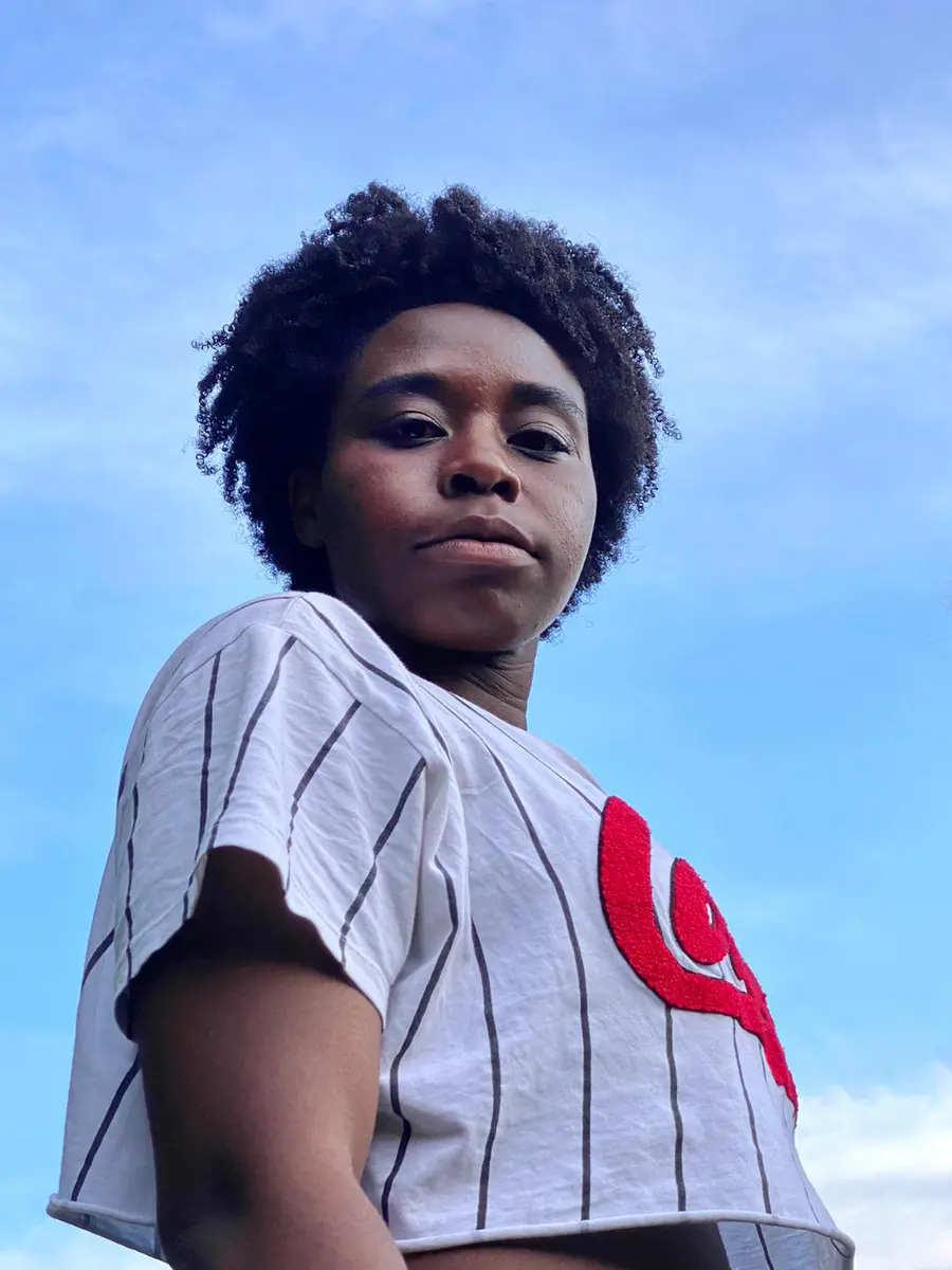 Headshot of a woman looking down into the camera 
