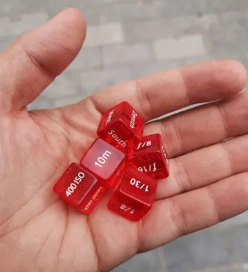 Image of hand holding the Photo Dice sold at TPG shop