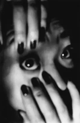 Black & white image of a woman looking straight to camera in close-up holding her right eye open by Daido Moriyama for The Photographers' Gallery