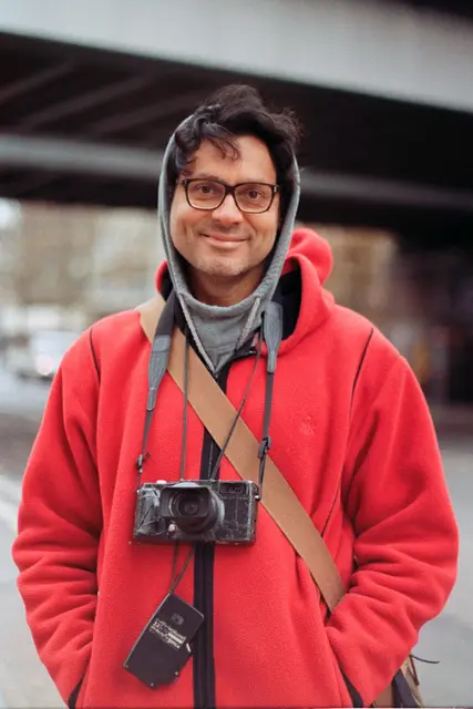 Portrait of Photographer wearing a bright red coat.