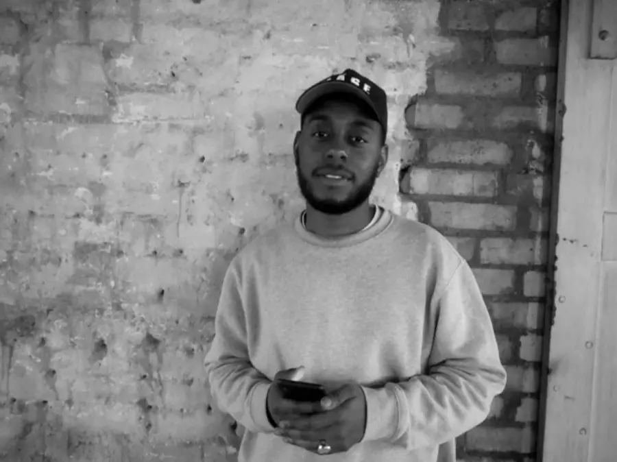 Black and white portrait of Photographer wearing a cap.