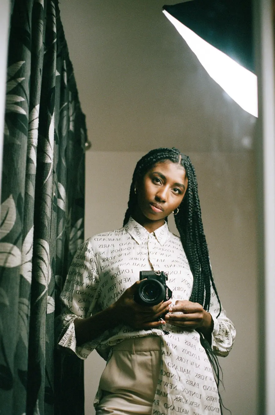 Self-portait of woman through a mirror reflection.