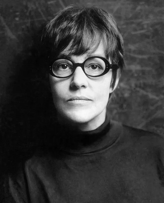 Black and white photograph of a woman with short hair and glasses