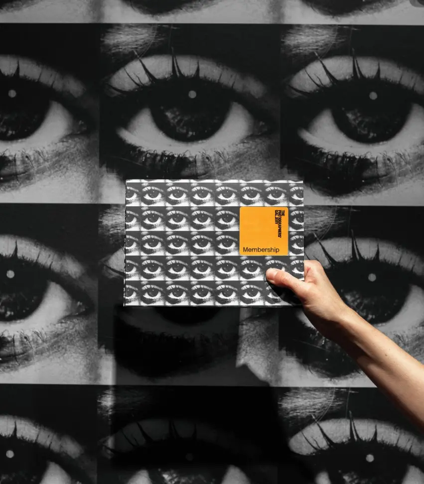 Colour photograph of a person's arm holding up a membership pack