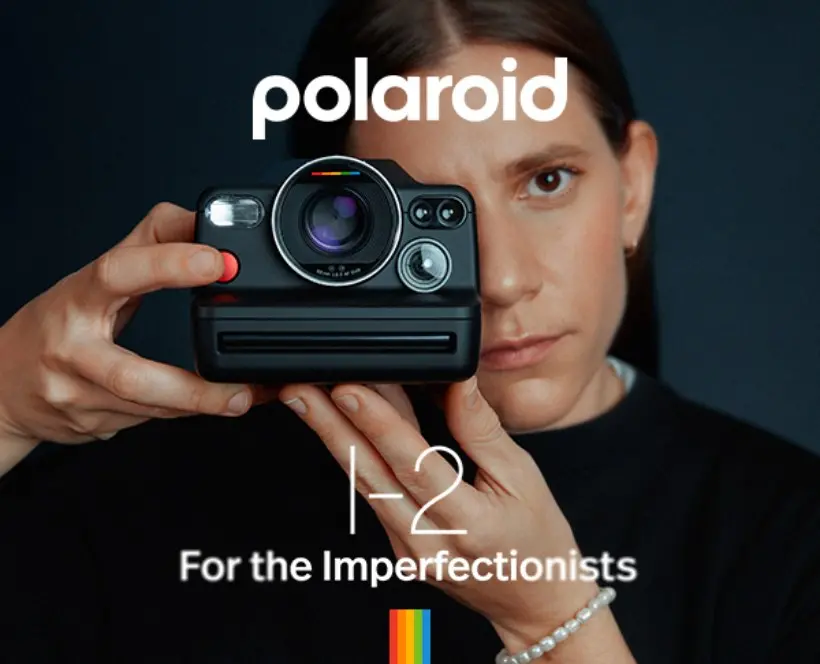 Colour photograph of a person holding a Polaroid I-2 camera