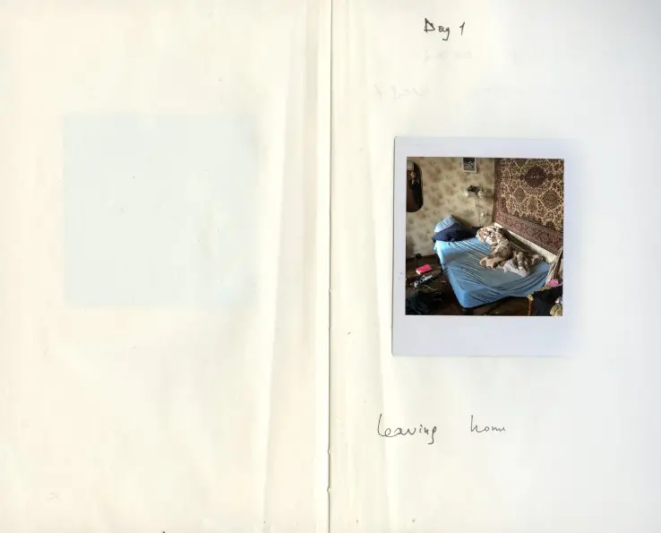 Colour photograph of a page from a diary with a polaroid photo and handwritten text Day 1 leaving home