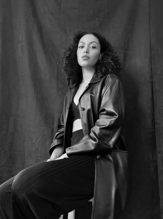 A photo of someone looking directly into the camera in black and white. 