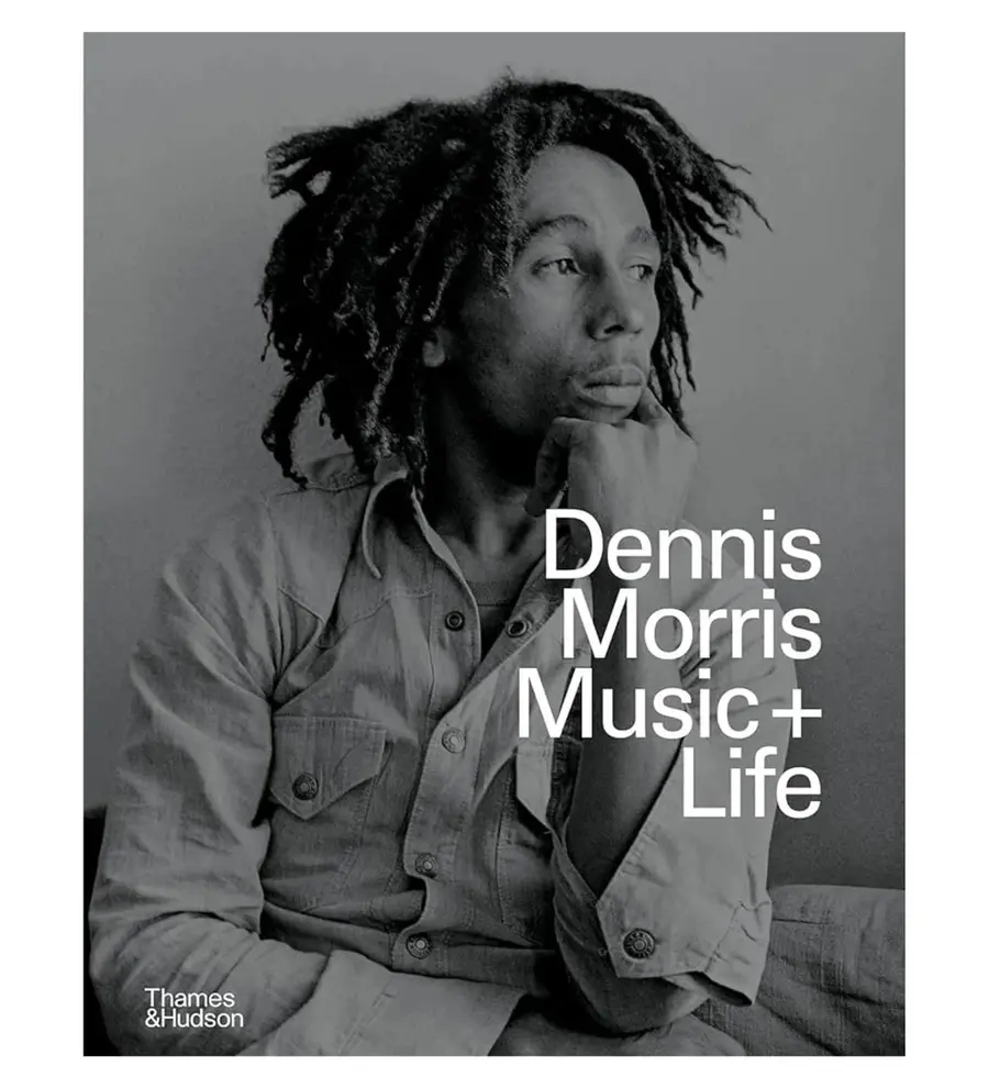 Image of a book cover. The cover is a large black and white image of a portrait photograph of Bob Marley overlayed with the title text, 'Dennis Morris: Music + Life'.