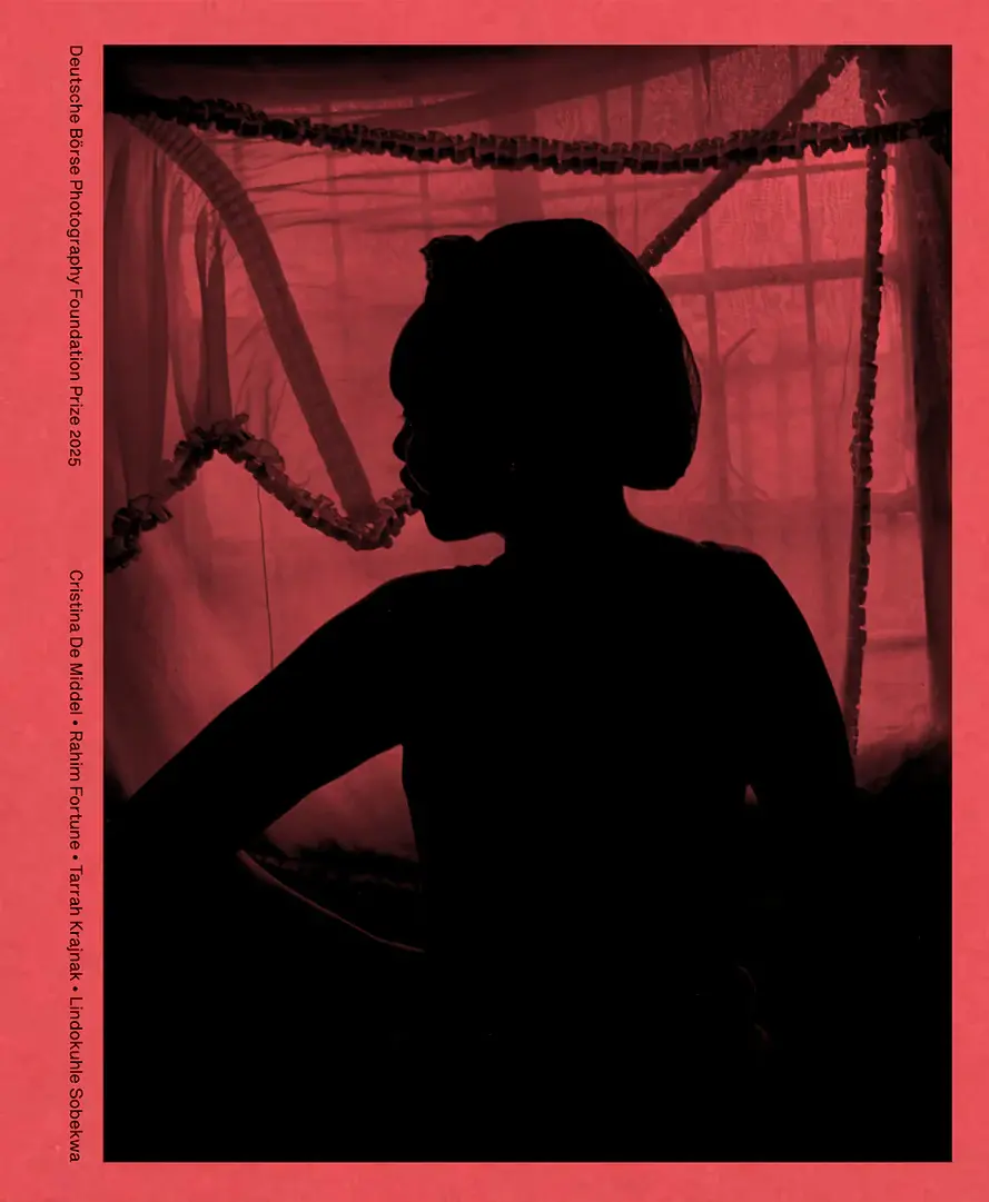 Image of the cover of a red book with a black silhouette of a woman looking to the side on the front.
