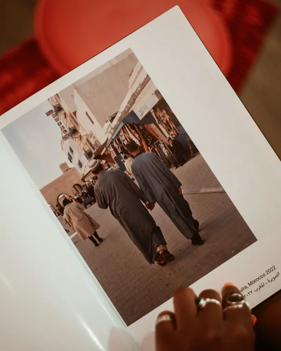 An open book with a hand holding it 