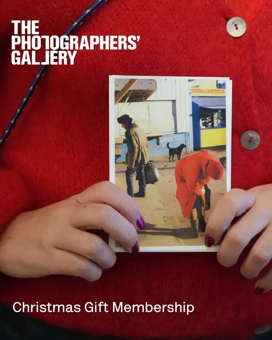 A close up of hands holding a postcard.