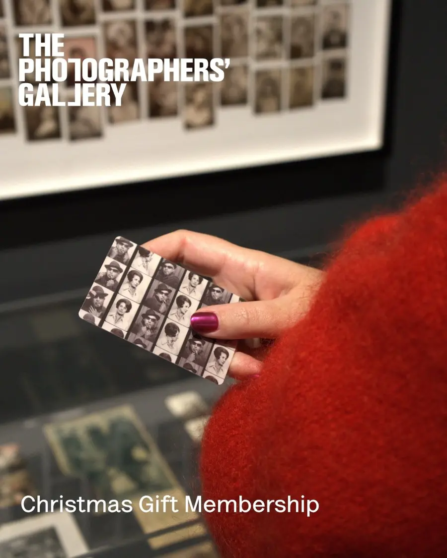 A close up of a hand holding a plastic membership card.