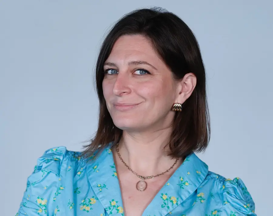 a headshot of a white woman with short brown hair styled in a bob