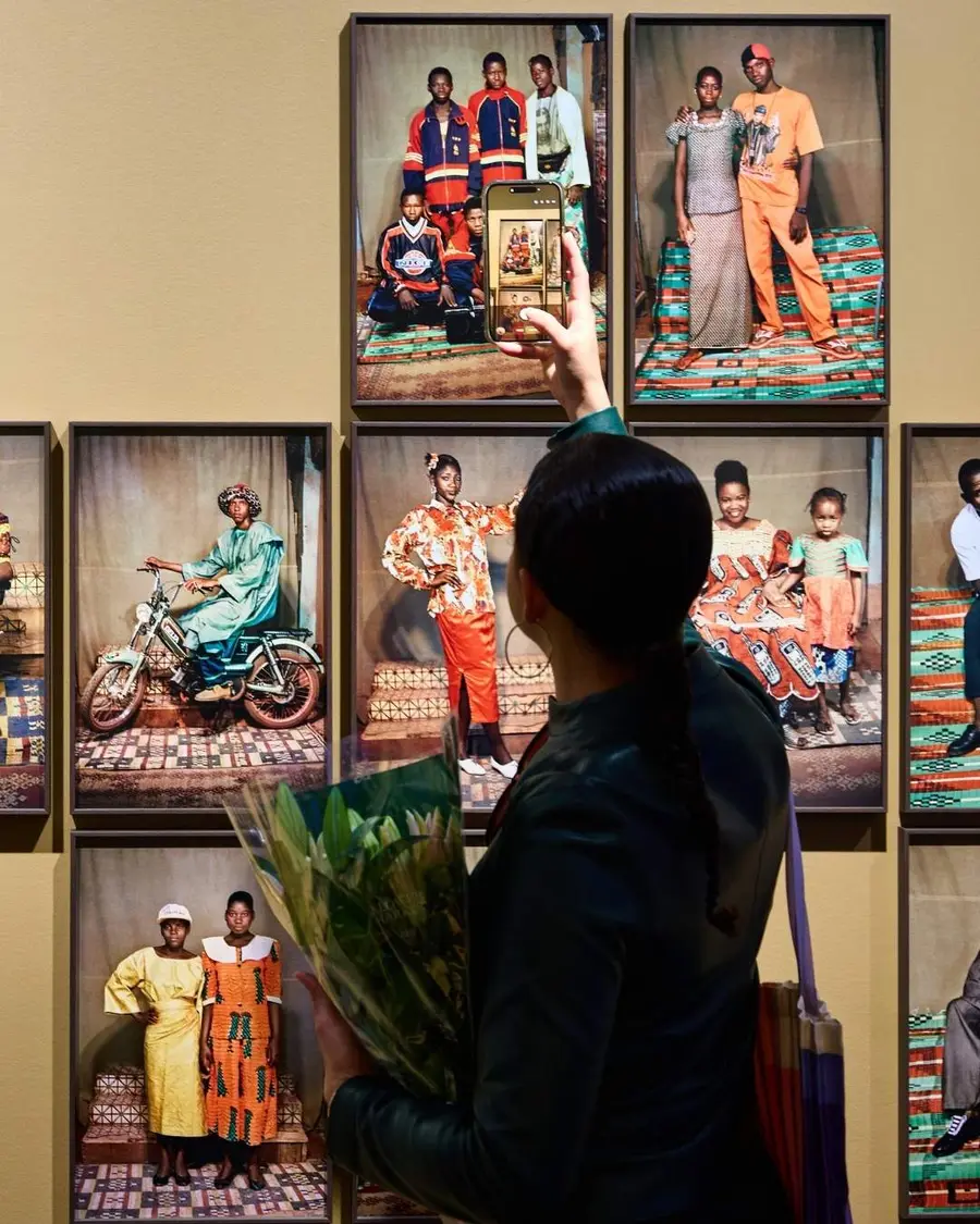 A perosn taking a photo of an exhibition space.
