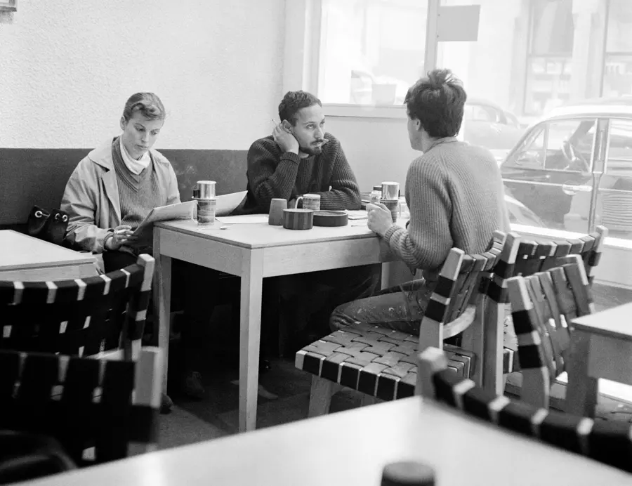 Black and White Photograph, by Roger Mayne, showing Stuart Hall playing chess with two other men at the Partisan Coffee House, displayed at The Photographers' Gallery in London