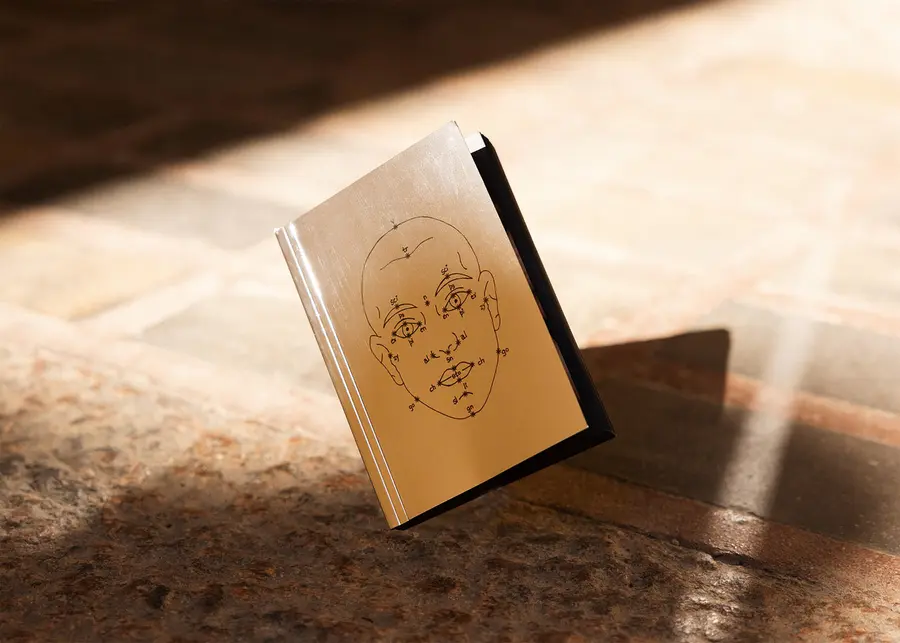 a book with a mirrored surface on a sunblessed table