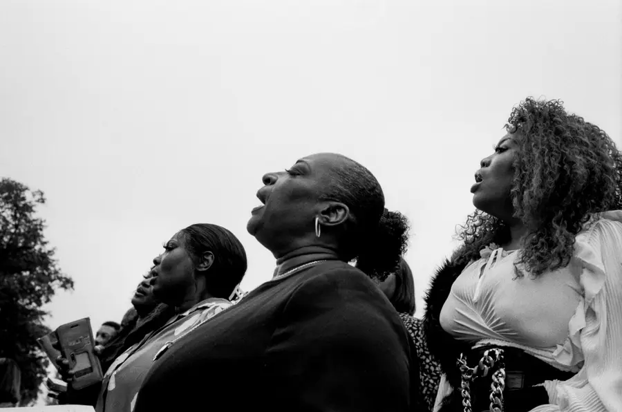 black and white photograph of heads lifted in praise