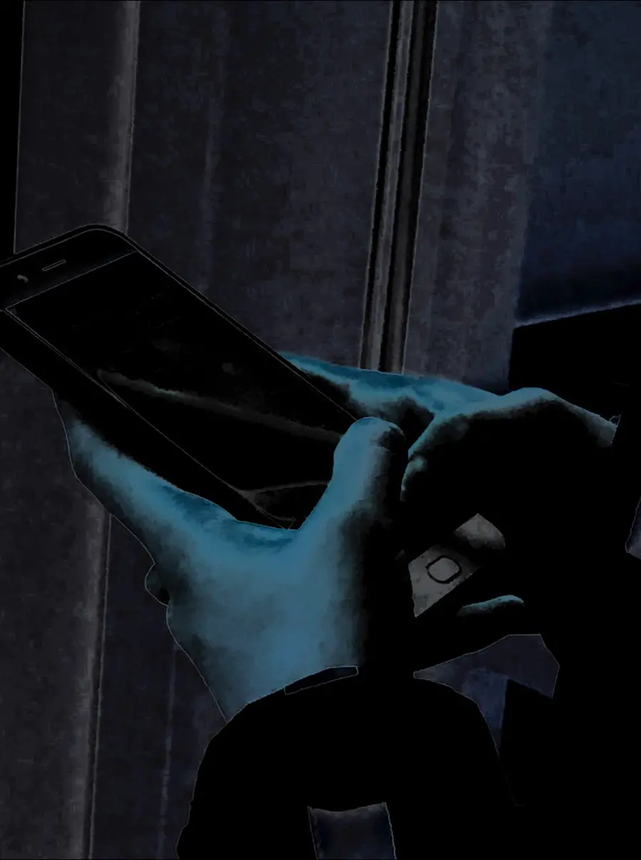 Dark blue close-up picture of hands holding a smartphone.