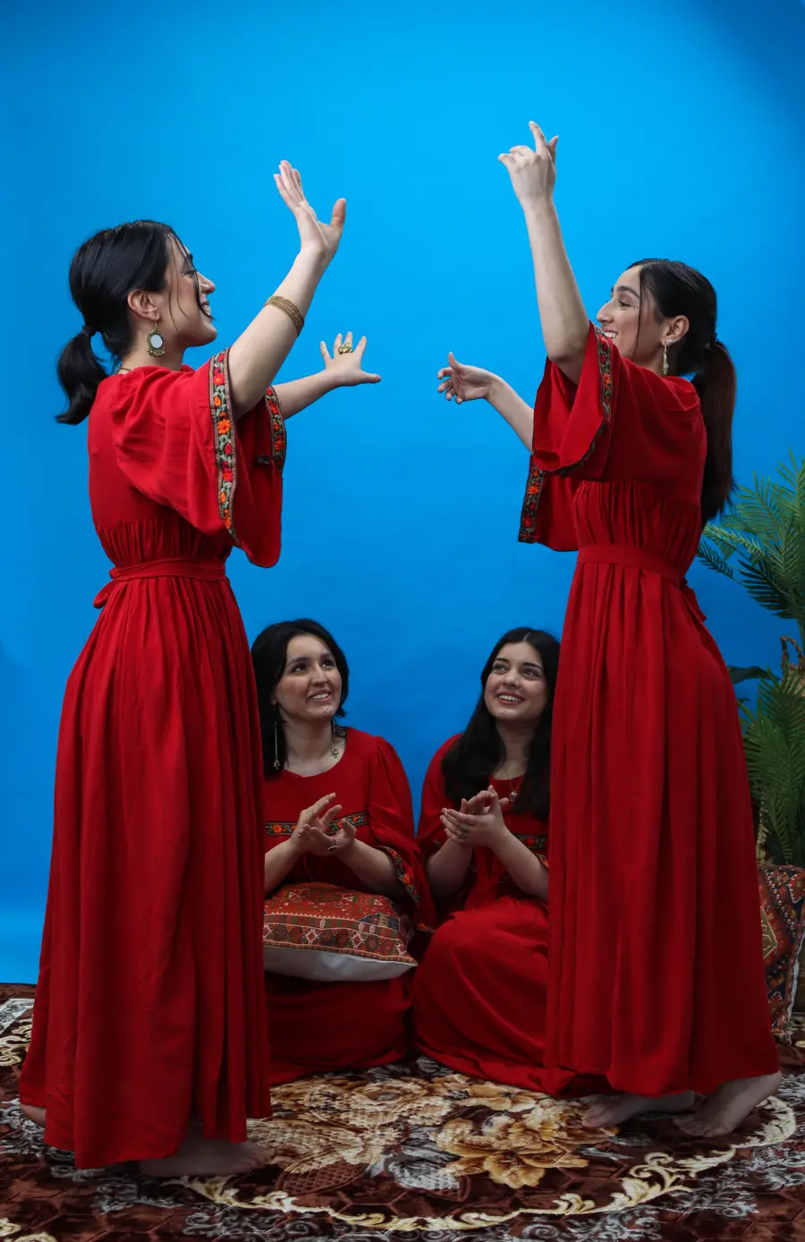 Photograph of group of women in traditional Afghanistan clothing and accessories. 