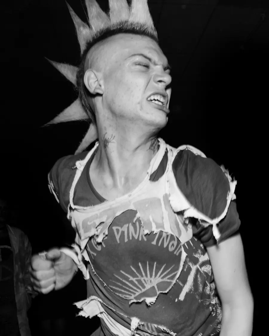 Black and white photograph of a male punk, dancing