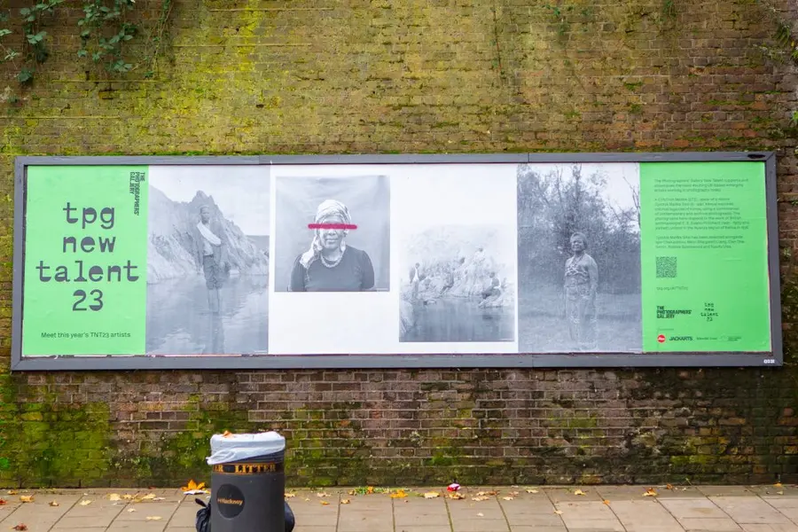 Colour photograph of a bilboard with black and white images and text 'TPG new talent 23'