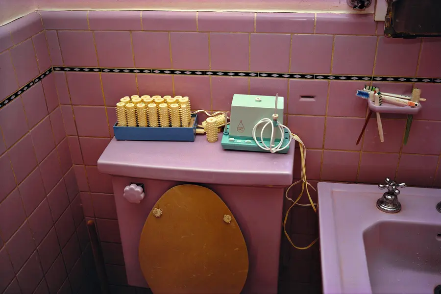 Colour photograph of a pink bathroom, including a pink bathtub, pink walls and a pink toilet.