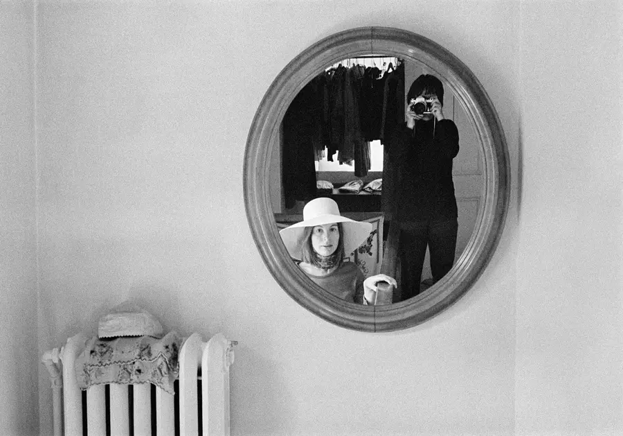 Black and White photography of Evelyn Hofer taking a photograph of a mirror reflecting her image and another woman sitting next to her