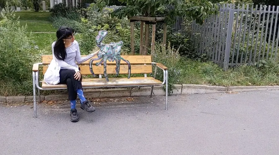 A woman sitting on a bench next to an augmented reality creature