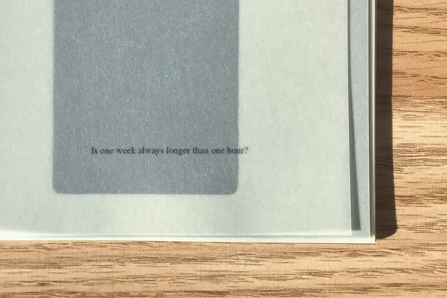 A photograph of a book cover on a wooden table. 