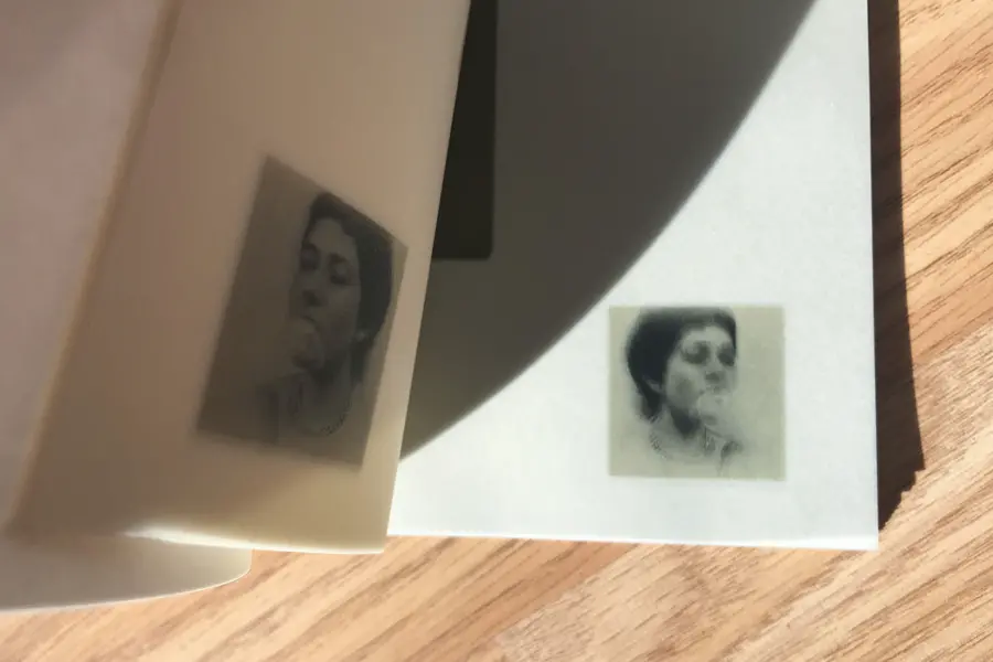 A photograph of a page turn on a wooden table.