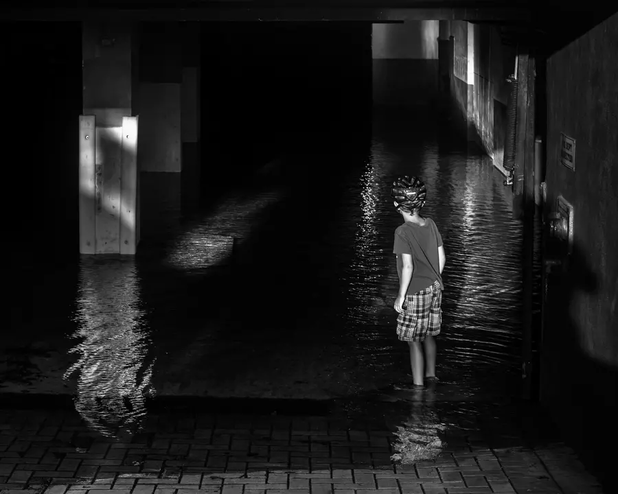 Boy in a flooded garage after Hurricane Irma