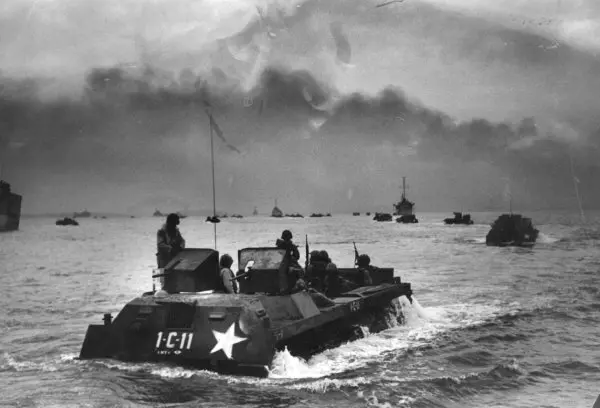 Black and white photo of a US assault craft moving through the waters