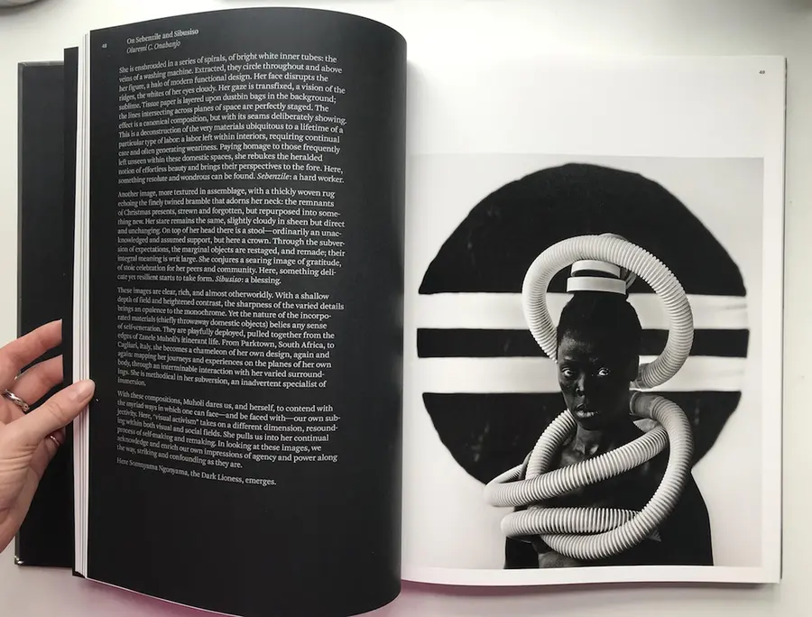 Book open with writing on the left side and a portrait on the right.