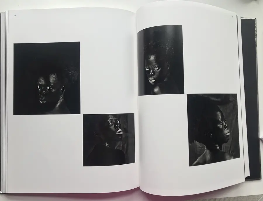 Book open on a two page spread of 4 portraits. 