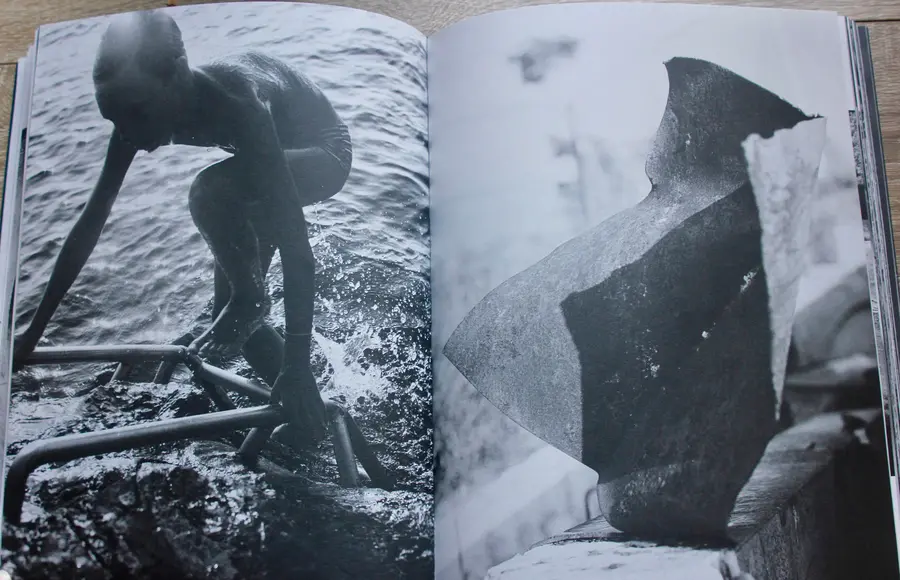 A book is open on a page of a person getting out of the sea. 