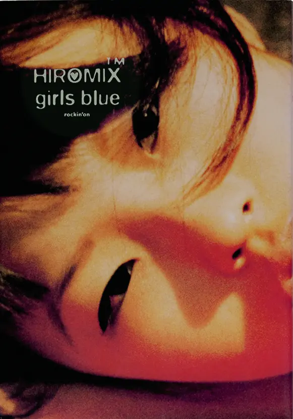 Close-up colour photograph of a woman’s  face with the words “HIROMIX girls blue, rockin’on” on the  picture. 