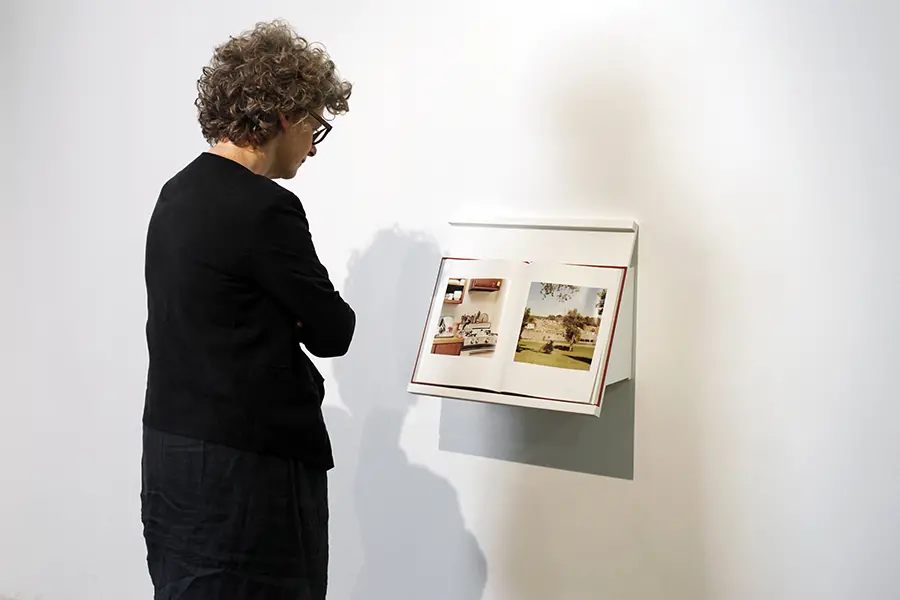 Woman looking at a book on display.