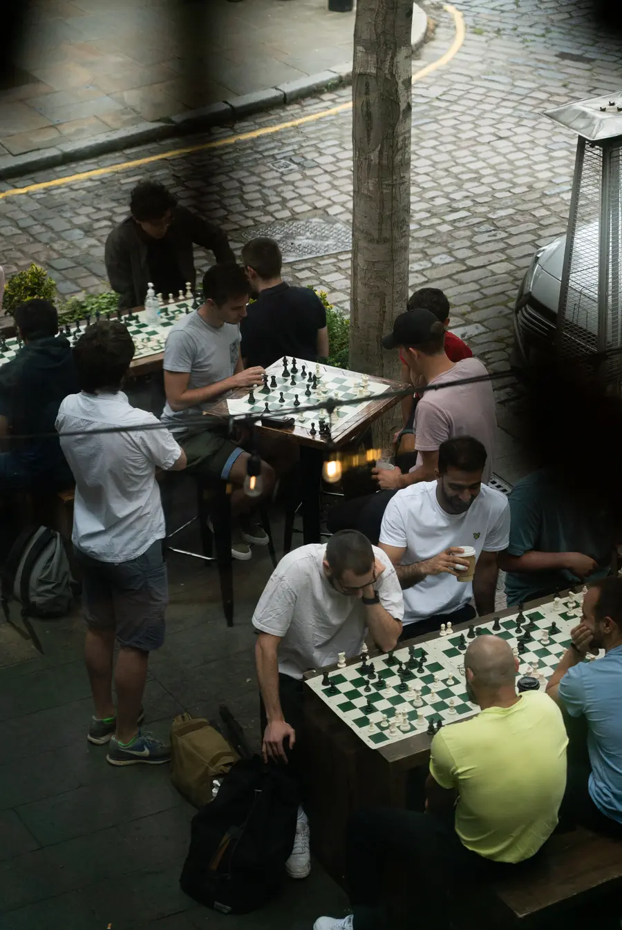 Image of people playing chess at an outdoors meetup