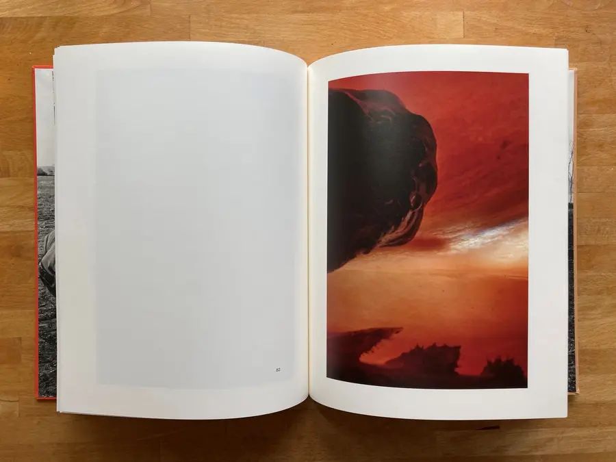 Full page spread, one image on the right hand side. The abract image is deep red, looks like a landscape of desert possibly. 