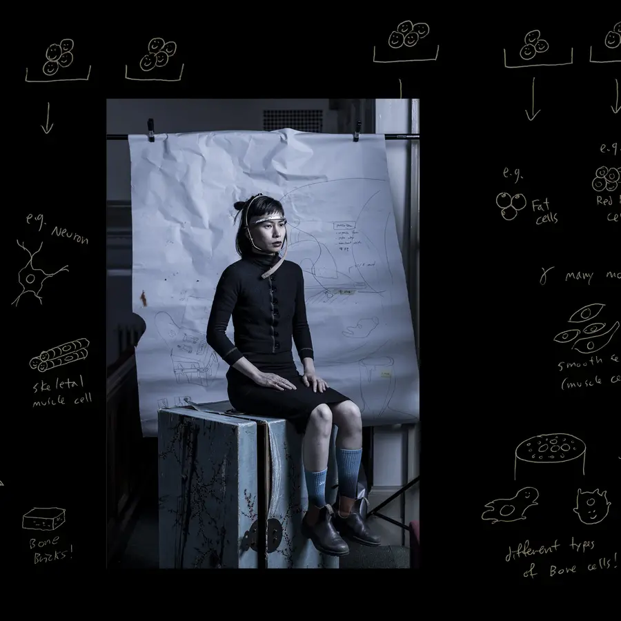 A person sits with a headpiece surrounded by annotations