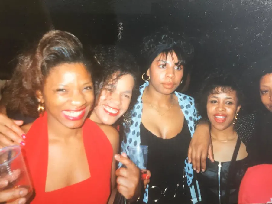 Film photograph of 4 people smiling at the camera