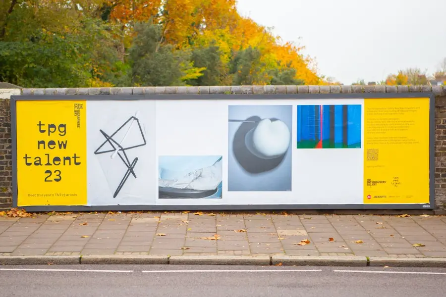 Colour photograph of billboard with colour photographs and text 'TPG new talent 23'
