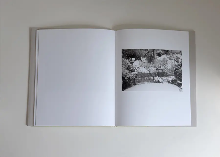 Book open showing black and white images of a garden.