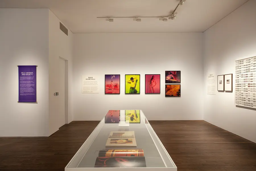 An image of a exhibition space with colourfal photographic prints on display