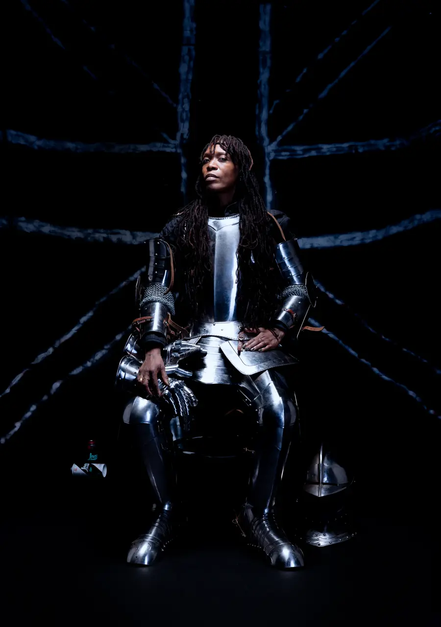 colour photo of a woman wearing knight's armour posing for the photograph