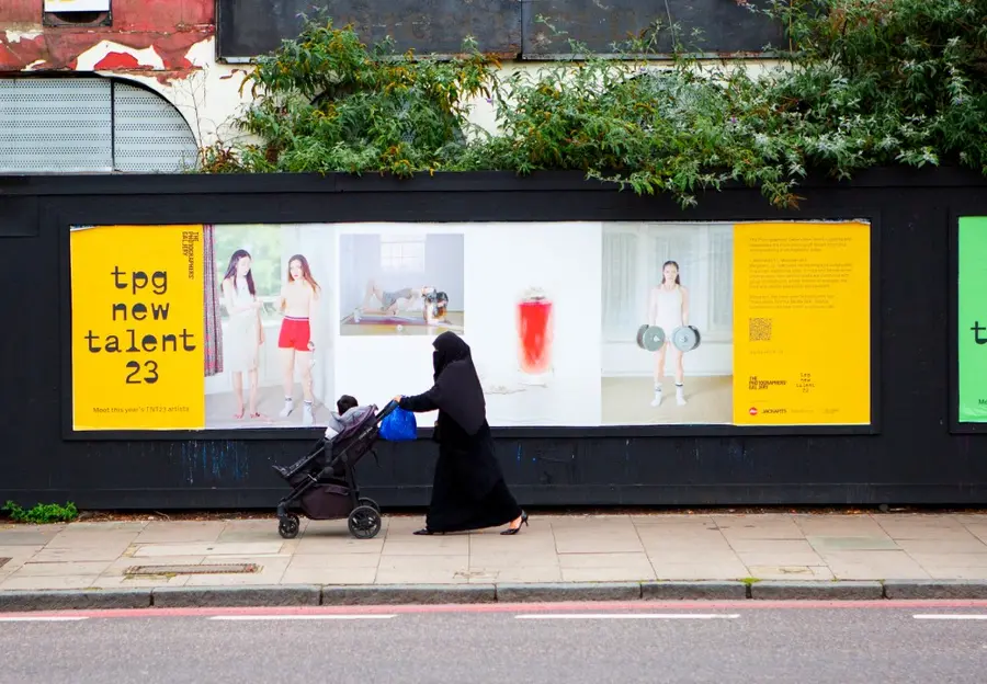 Colour photograph of a billboard and street scene with colour photographs on the billboard and text 'TPG new talent 23'